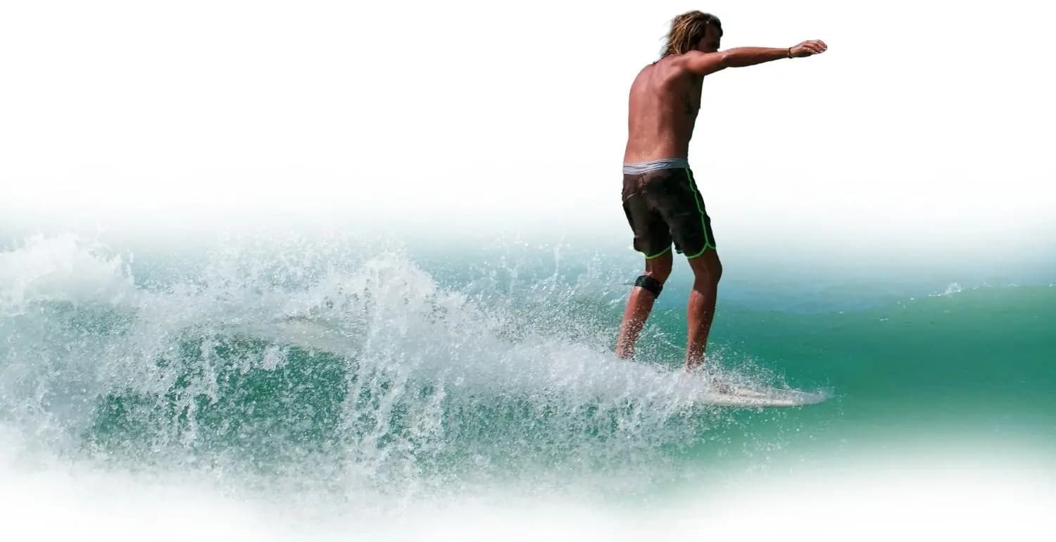 A surfer riding a breaking wave